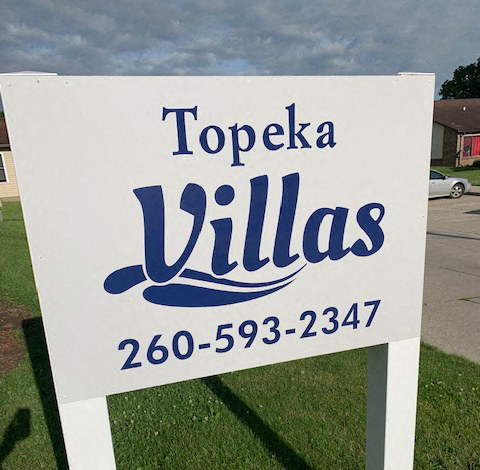 a white sign villages on the side of the street